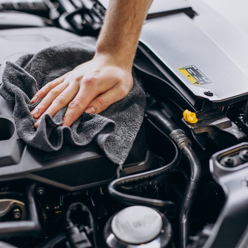 Man polishing car inside at car service
